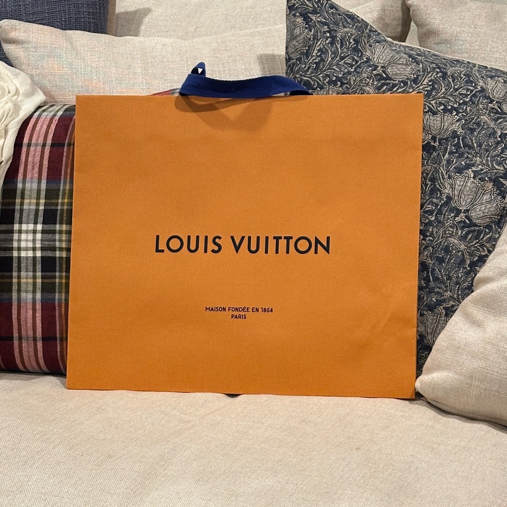Authentic Louis Vuitton shopping bag. This is the brand's signature packaging.